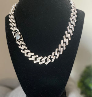 20” Iced Out Cuban Link Chain in silver tone. Brilliant shine and clustered is white Rhinestone.